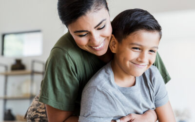 Mom gives son a hug in the living room